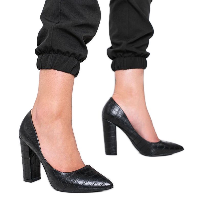 Black pumps on a post with a snake skin pattern This Way