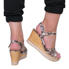 Beige wedge sandals in the Peekaboo snake skin pattern Beige wedge sandals in the Peekaboo snake skin pattern