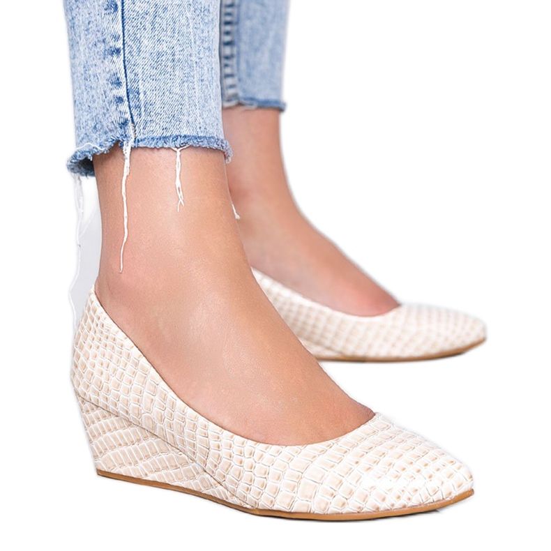 Beige pumps in a crocodile skin pattern on the Wildlife wedge heel
