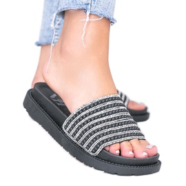 Black slippers richly decorated by Trisha