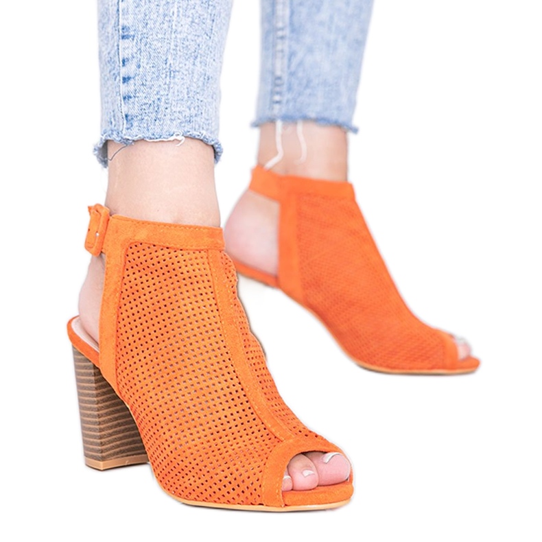 Orange openwork sandals on the Bite post