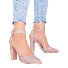 Pink shiny pumps on Mila's post golden