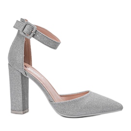 Shiny silver pumps on Mila's post