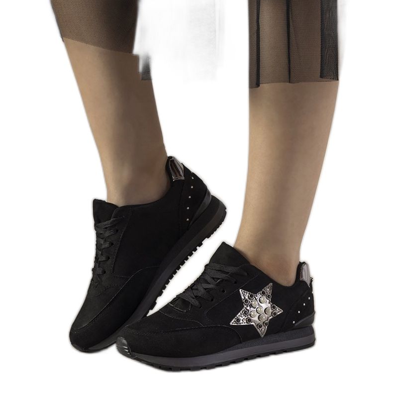 Black sports sneakers decorated with Ruler studs