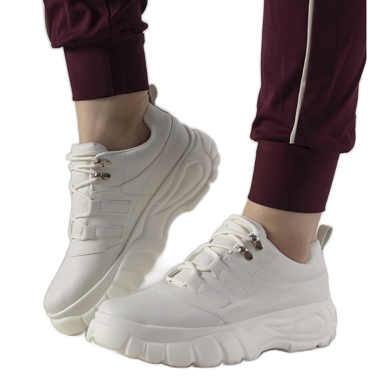 White sports sneakers with a high Luna sole