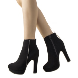 Black elegant boots on the Torment post