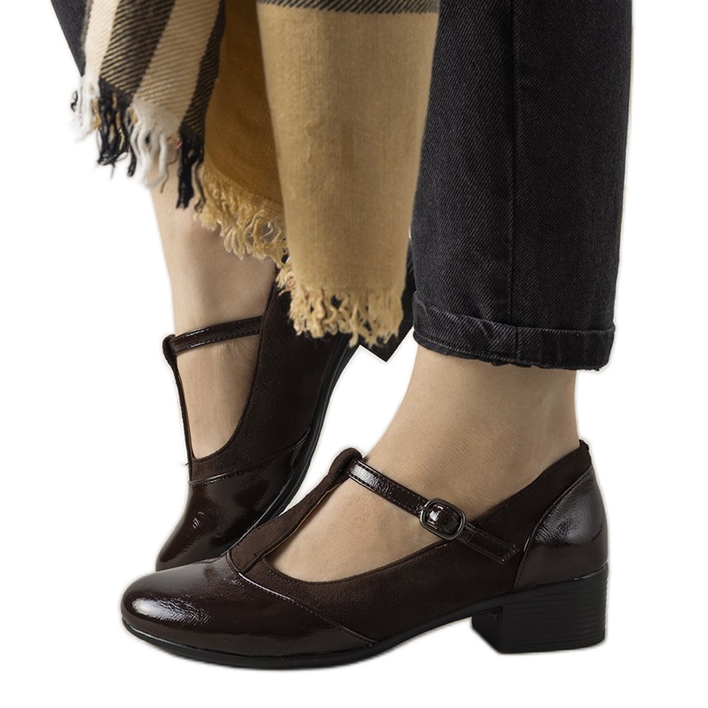 Brown pumps on a pillar with a varnished Manam toe