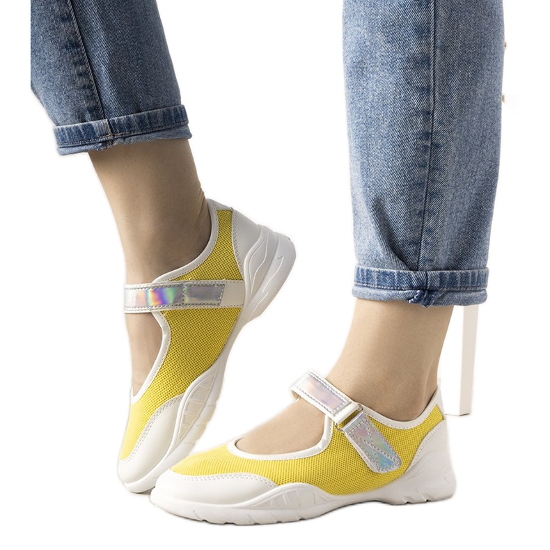 Yellow and white trainers with a holographic Melania insert