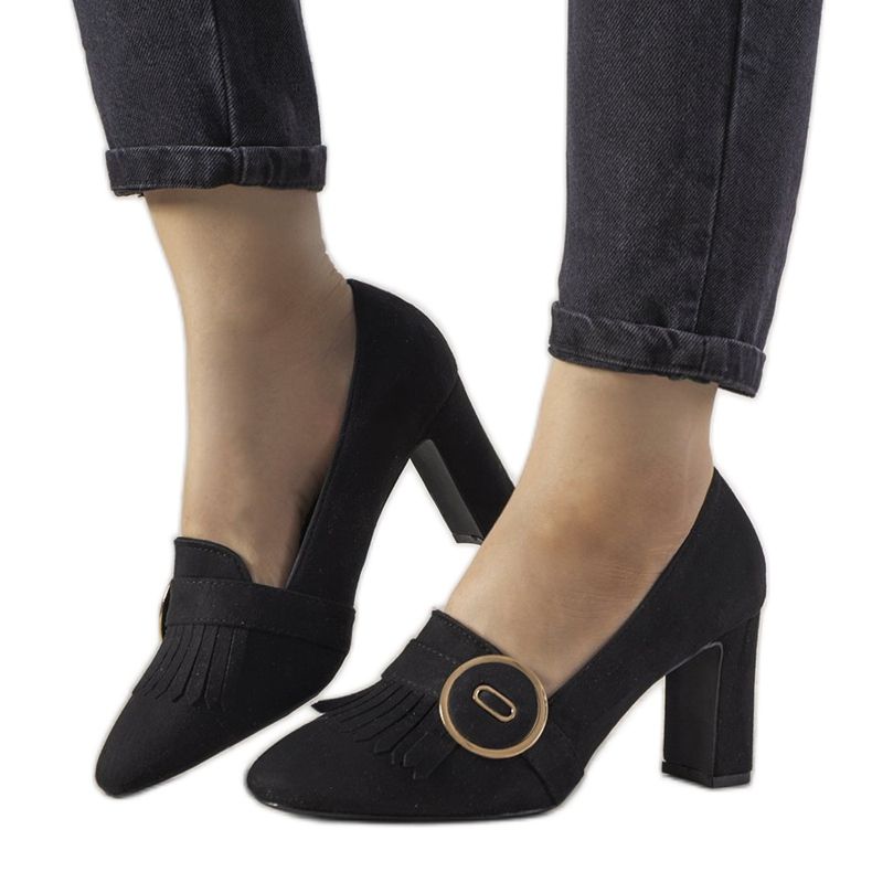 Black pumps on a post with a Promise buckle