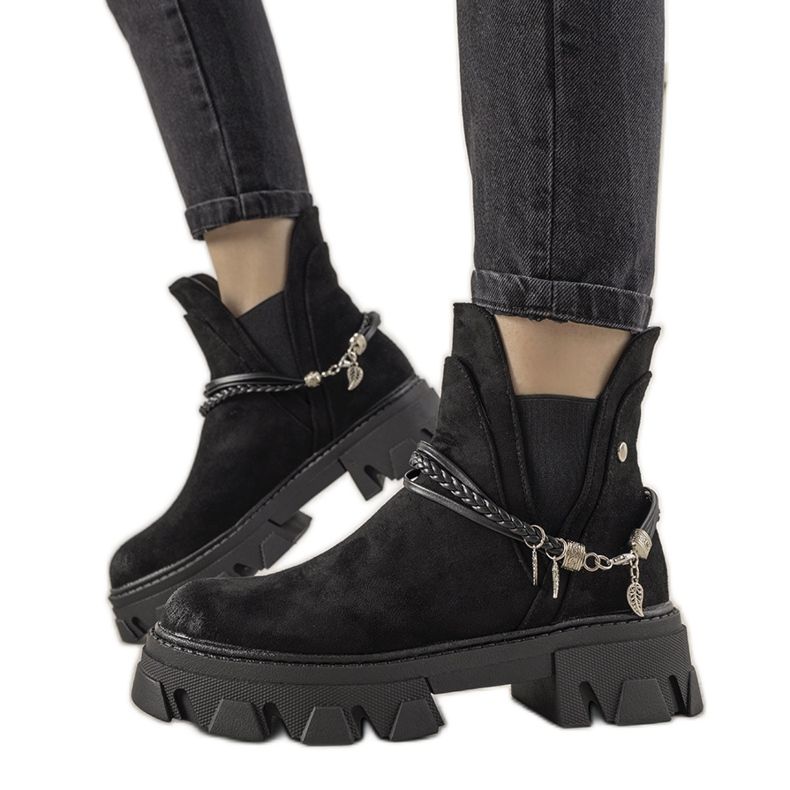 Black boots with a Fearless bracelet