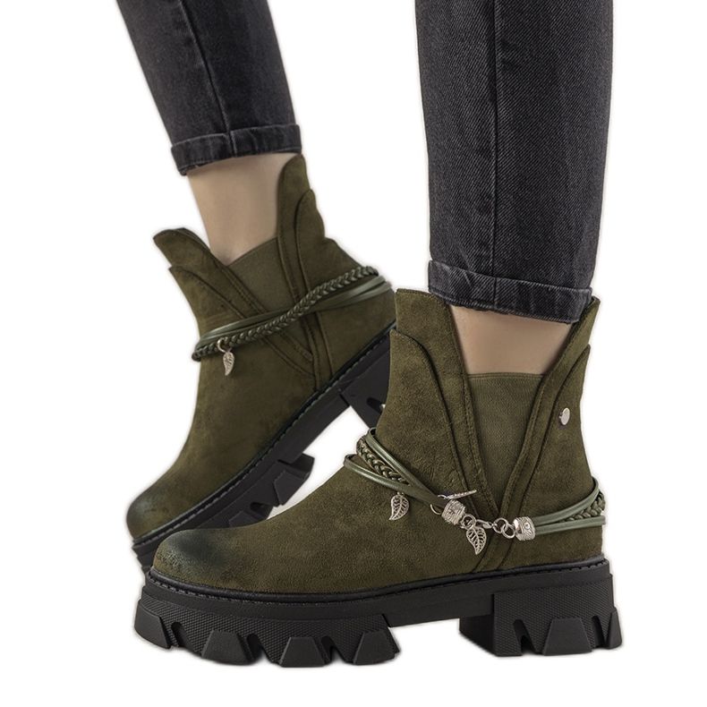 Green boots with a Fearless bracelet