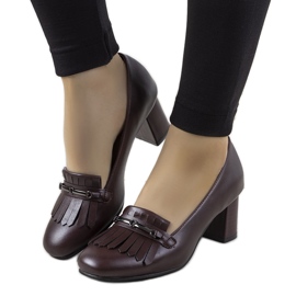 Maroon pumps on a post made of Alice's eco-leather red