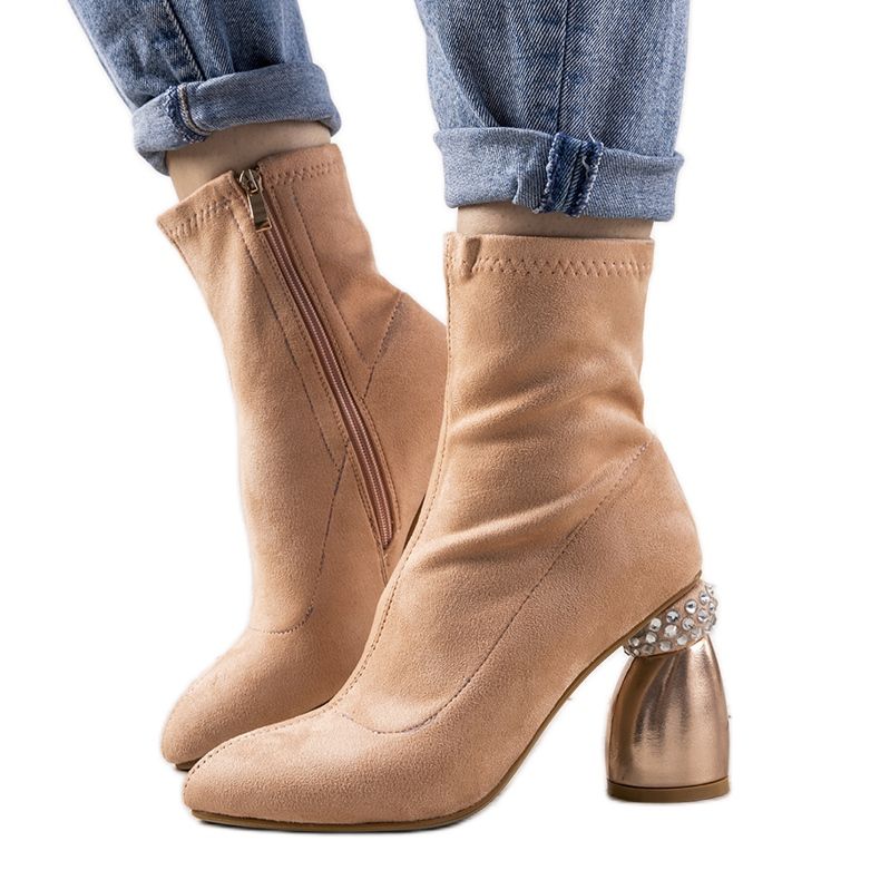Pink boots on a decorative Bazin post