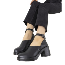 Black shoes on the post of Christiane