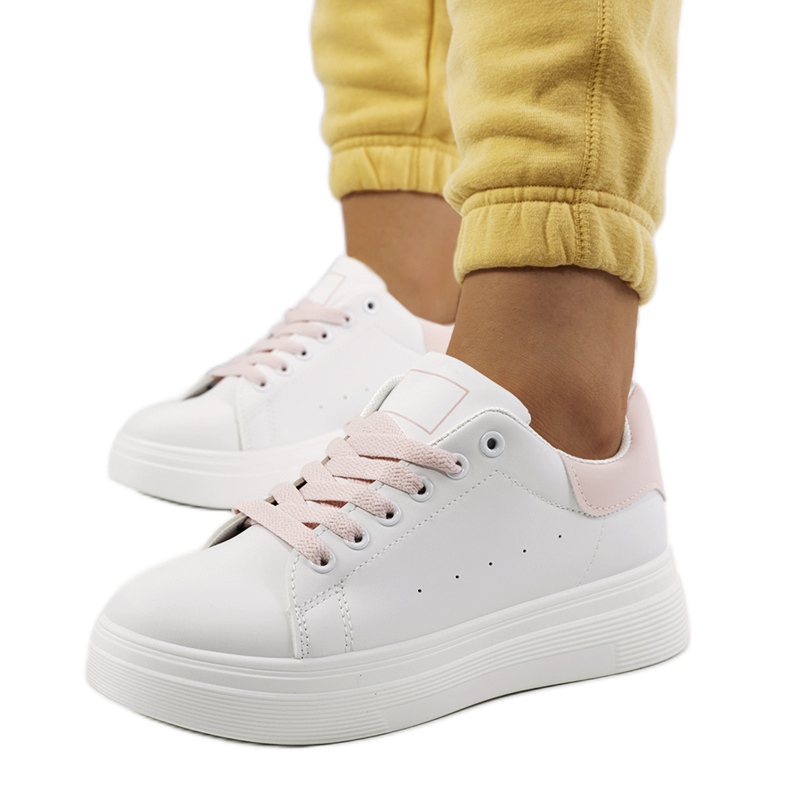 Pink and white sneakers on the Justar platform
