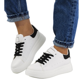 Black and white sneakers on the Justar platform