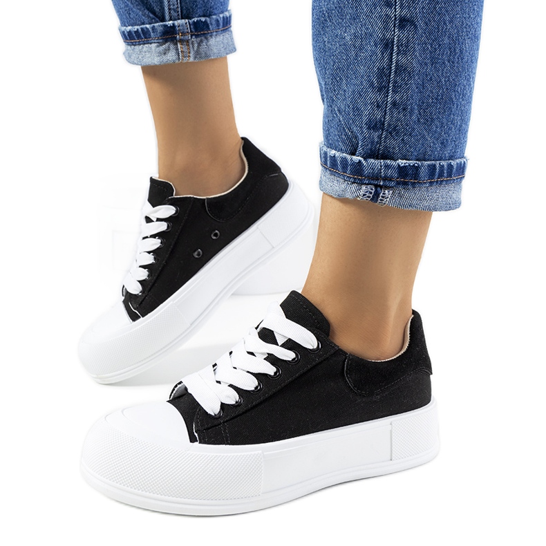 Black sneakers on the Venancia platform