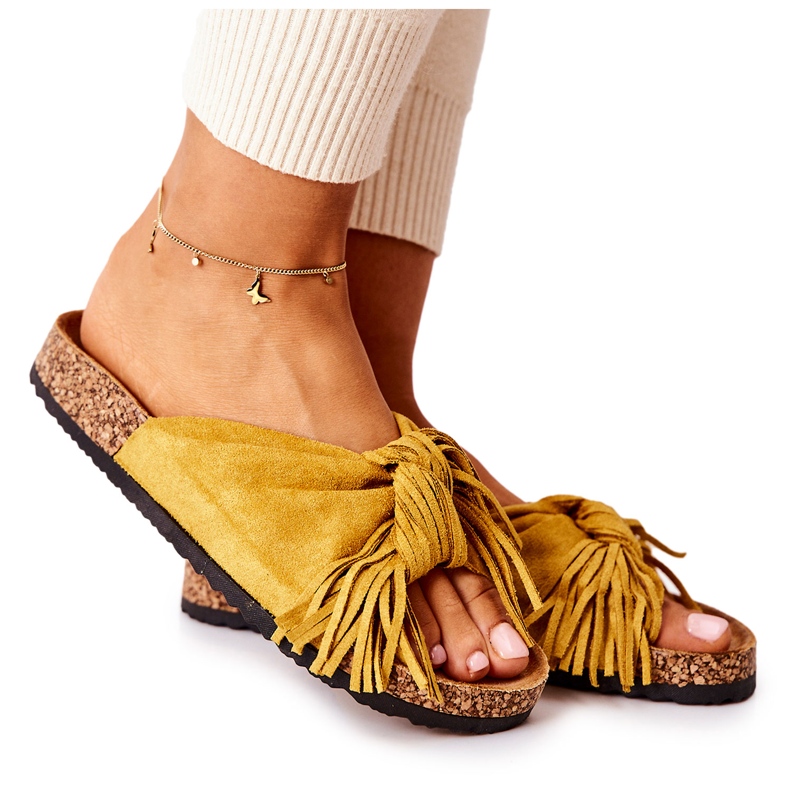 Yellow flip flops with a cork sole and fringes