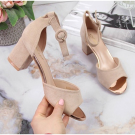 Women's sandals on a beige Vinceza post