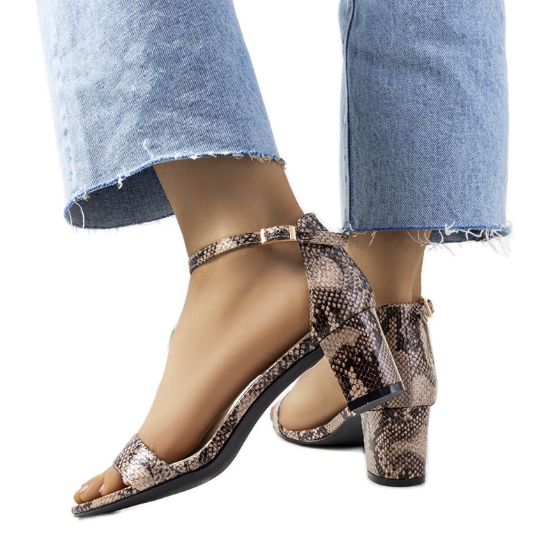 Beige sandals on a post with Azevedo snake motif