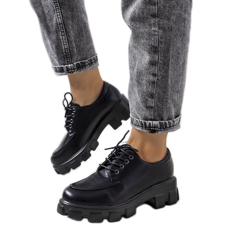 Black shoes on a Feline tractor sole