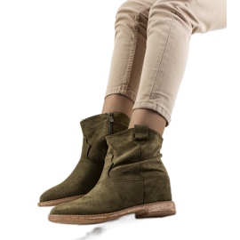 Green boots on an indoor Hunjet wedge heel