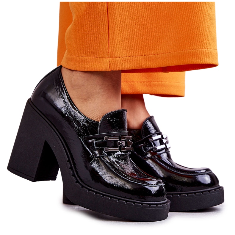 Lacquered shoes on a massive Black Jaime post