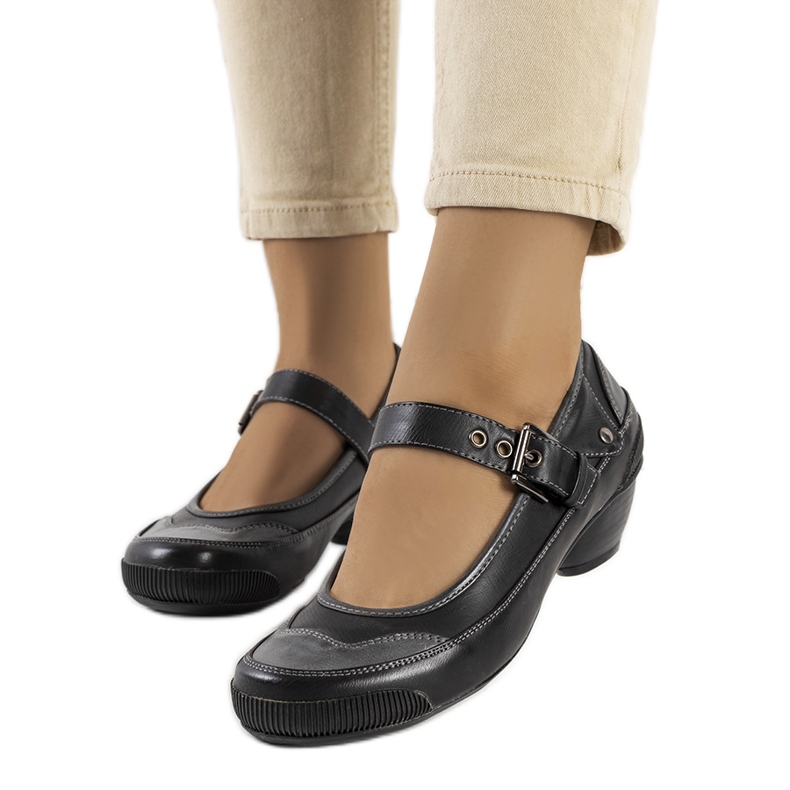 Black pumps fastened with a Via strap