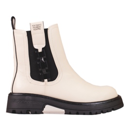 Cream women's Chelsea boots with a black sole beige