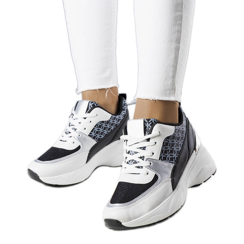 Black sneakers decorated with the Lora monogram