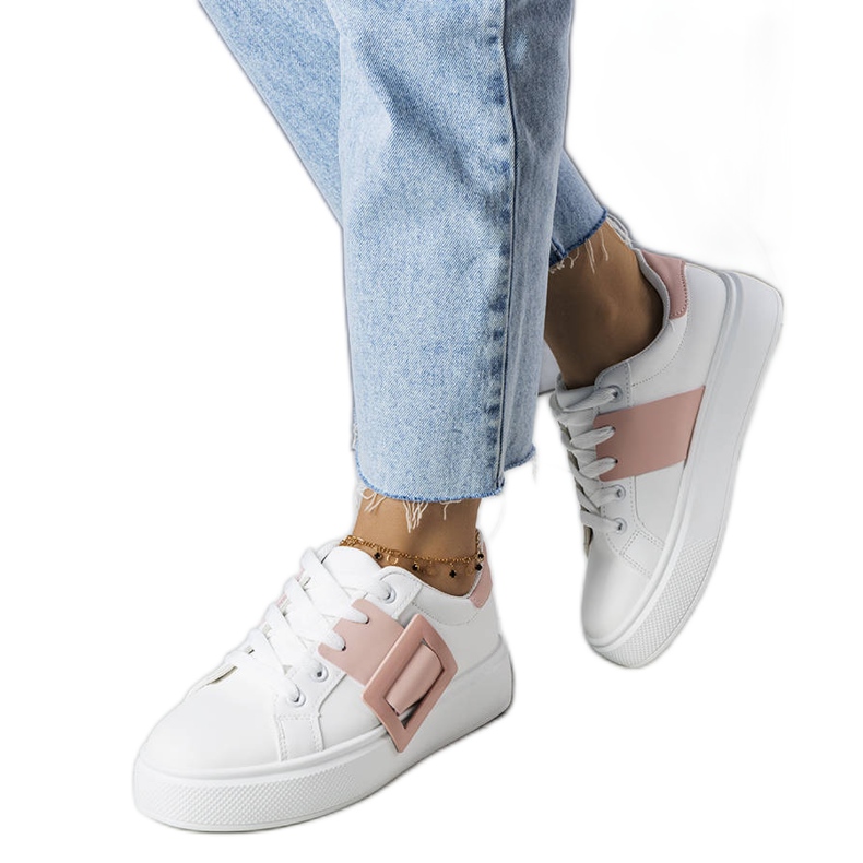 White sneakers decorated with a pink Toni buckle
