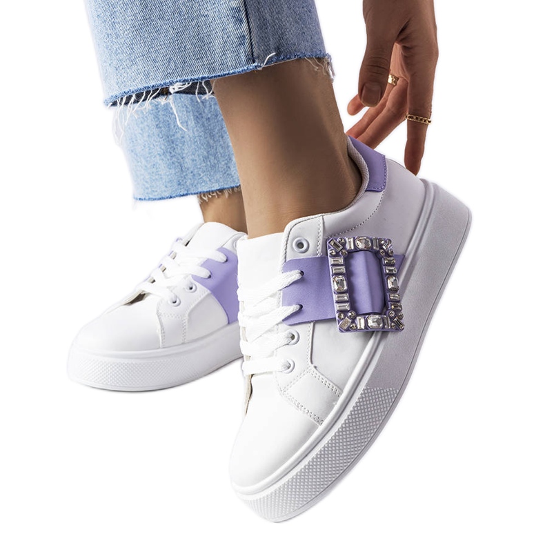 White sneakers decorated with a purple Ike buckle
