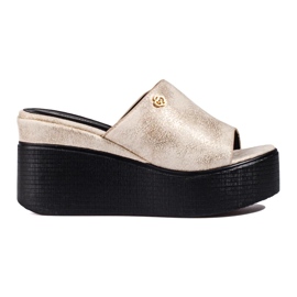 Metallic flip flops on a high wedge golden