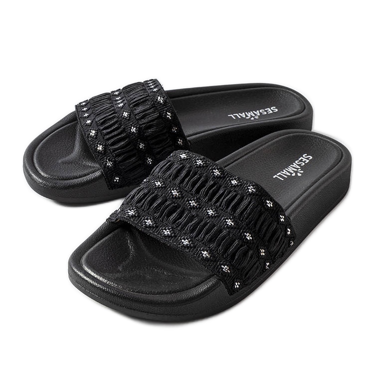 Black sliders decorated with ruffles from Ernest