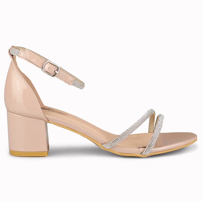Elegant shiny beige women's sandals on the post