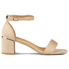 Beige sandals on a low heel with a golden detail