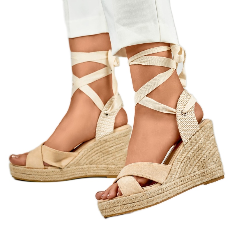 Beige women's sandals on the platform