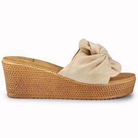 Beige women's slippers on a comfortable wedge heel