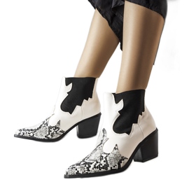 White insulated cowboy boots with a snake motif from Goulet White insulated cowboy boots with a snake motif from Goulet