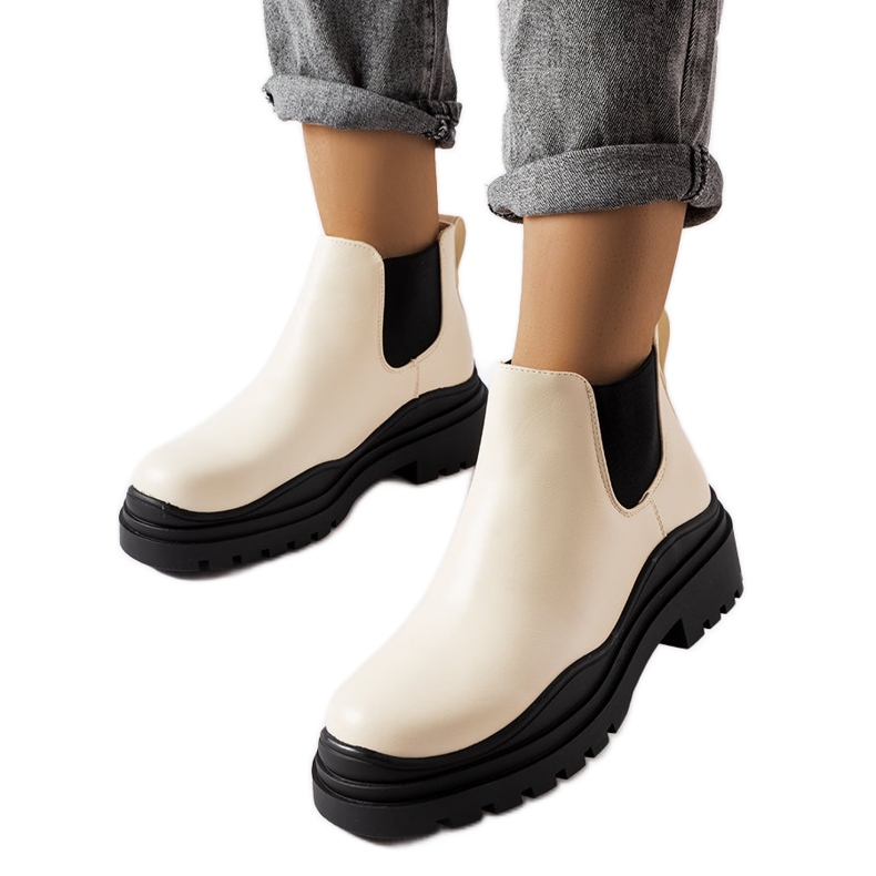 Beige ankle boots on a black platform from Marinone