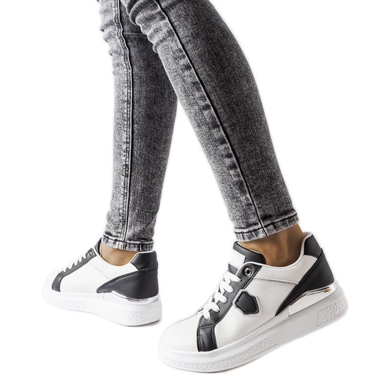 White and black sneakers with a silver accent from Via
