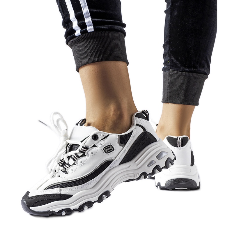 White and black sports sneakers by Kouri