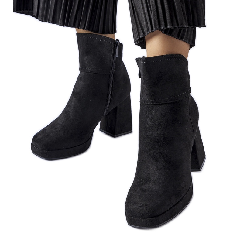 Black ankle boots on a massive Itaf heel