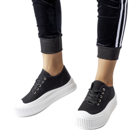 Black sneakers on a thick white Rina platform