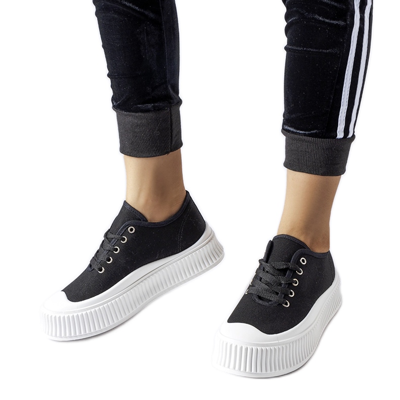 Black sneakers on a thick white Rina platform