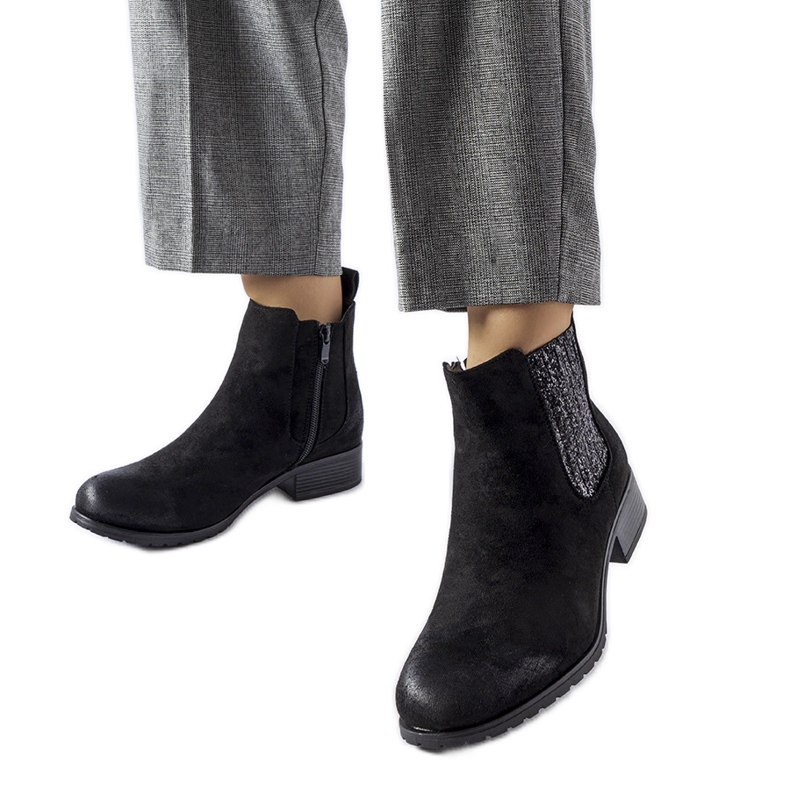 Black flat ankle boots with a decorative Arnoux insert