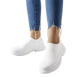 White slip-on sneakers on the Baratili platform