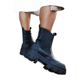 Black ankle boots with visible Moriano tread