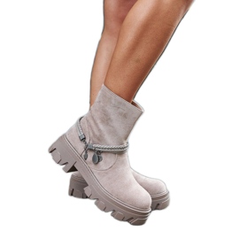 Beige ankle boots with a decorative bracelet