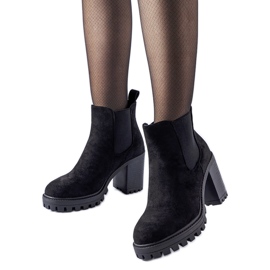 Black ankle boots on a massive Montelparo heel